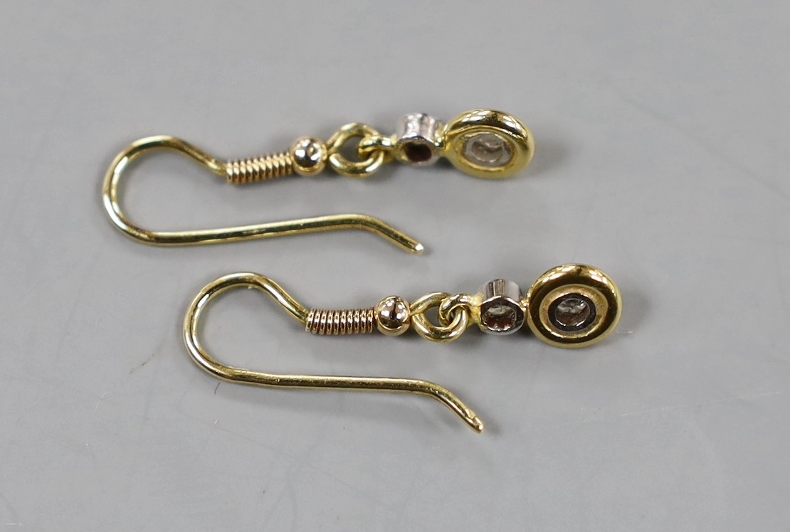 A pair of yellow metal and two stone diamond set drop earrings, overall 25mm, gross weight 2.1 grams.